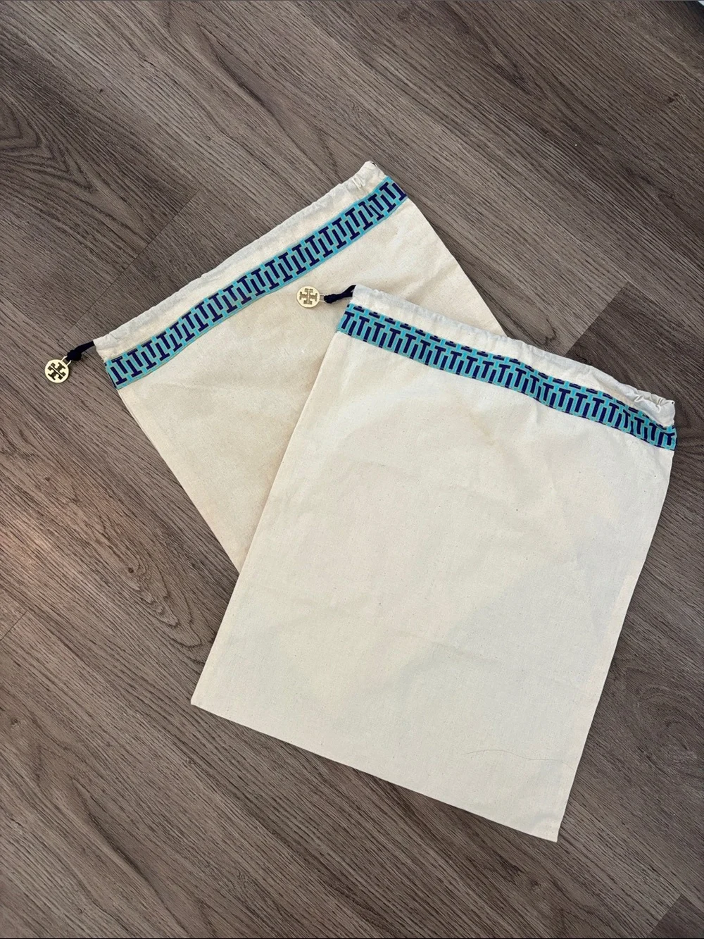 Set of 2 Tory Burch drawstring dust bags, canvas with gold charm